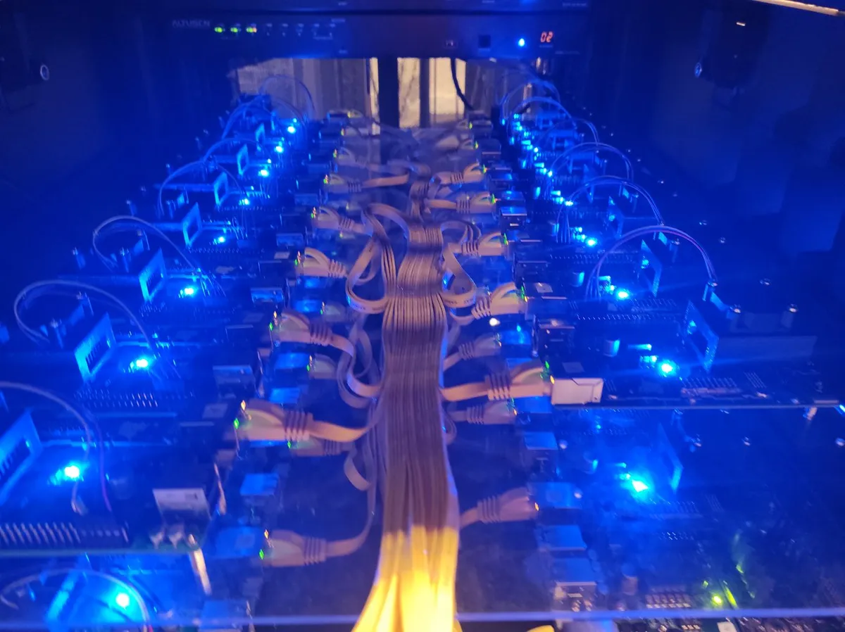 Rack of Citronics boards under test, lit in blue