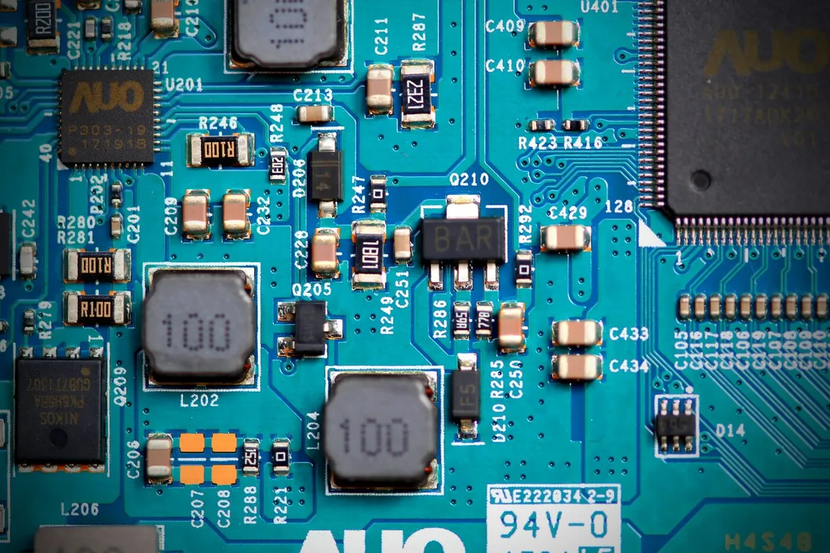 Close-up of a populated circuit board — driver ICs, power inductors and passives